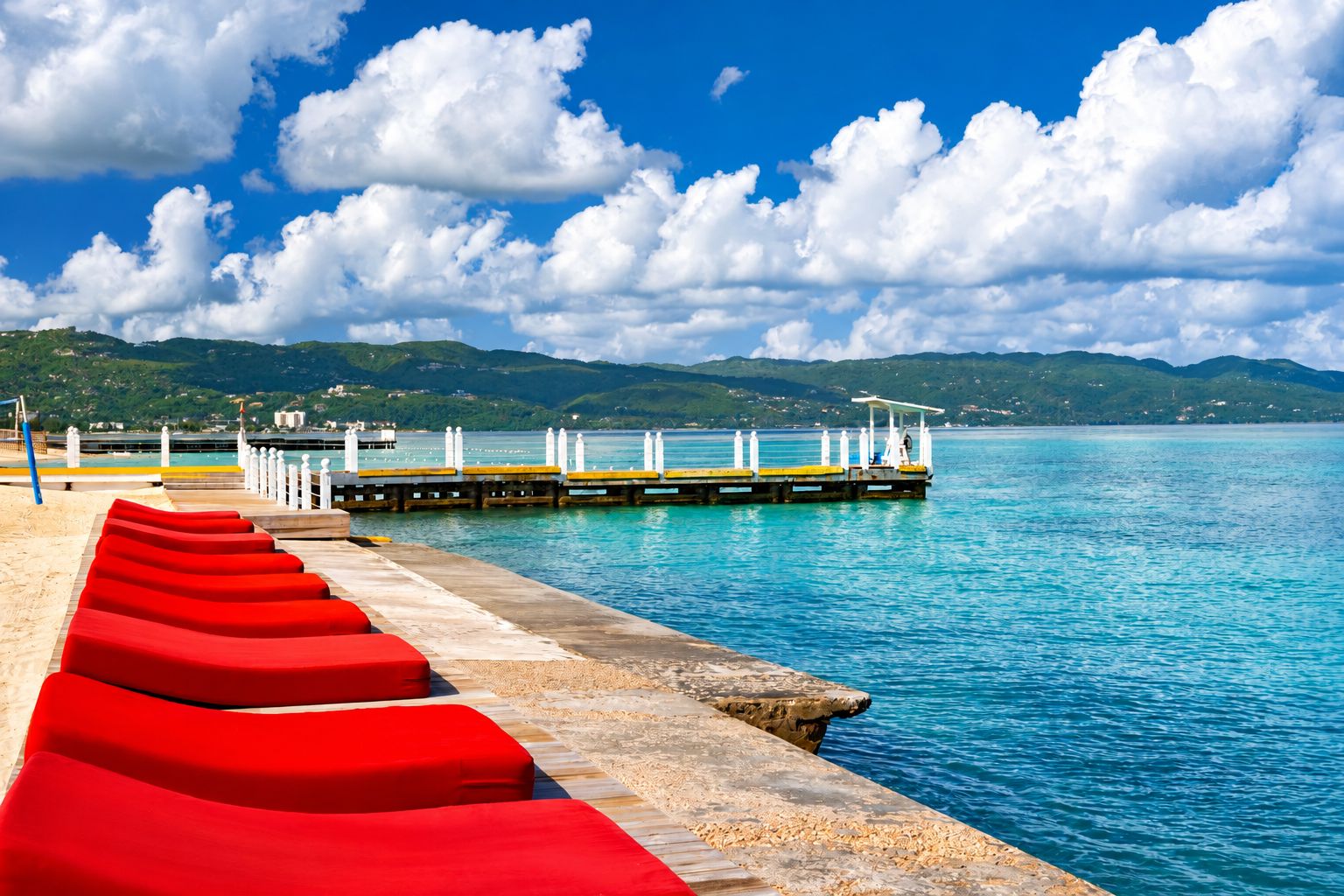Red loungers on the pier